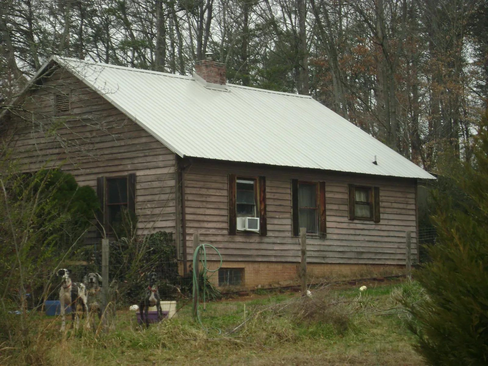 White metal roof on an old wood sided farmhouse, from a Metal Roof Installation job in Mc Henry